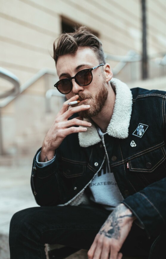 Steve smokes a cigarette.